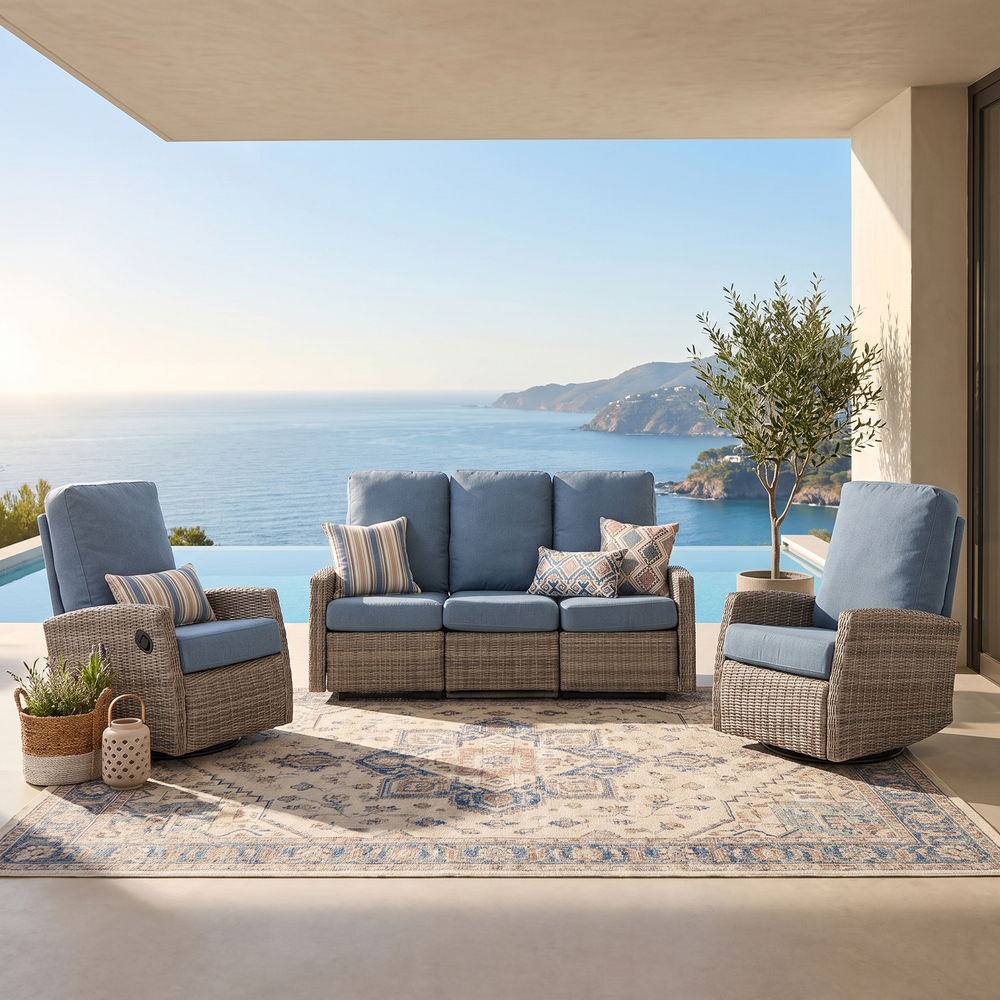 Keywest reclining sofa and two swivel recliners arranged on a covered patio overlooking the ocean